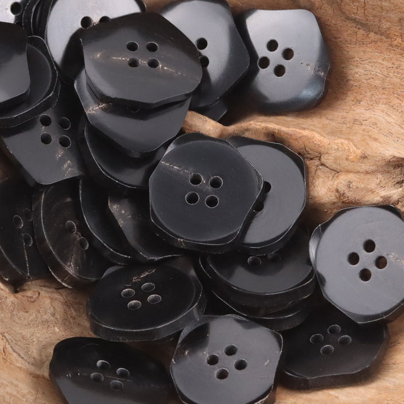Assorted dark ox horn buttons with four-hole exotic shapes