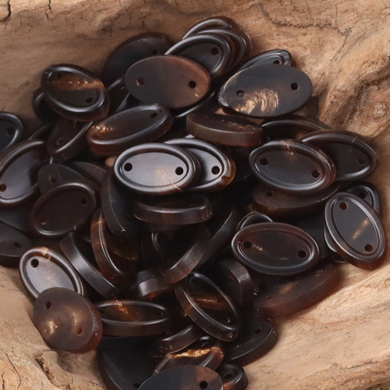 Pack of long oval two-hole ox horn buttons in mixed dark natural shades