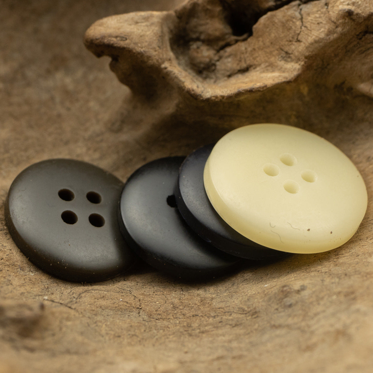 4-hole round flat resin buttons; dark gray, charcoal, pale yellow