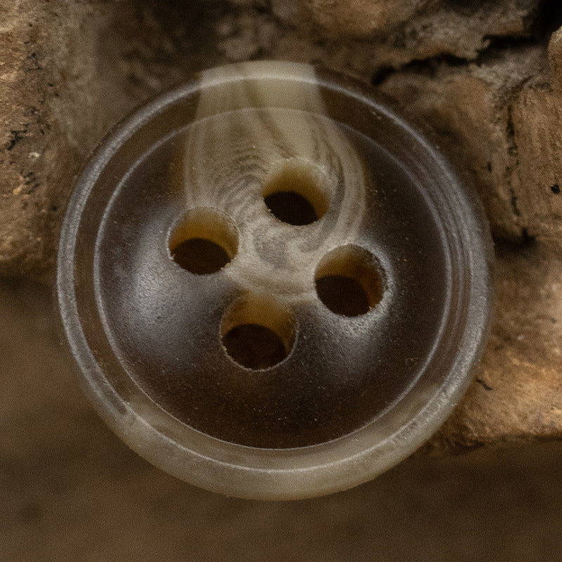Smoky gray-brown resin shirt button with four holes, glossy thin edge