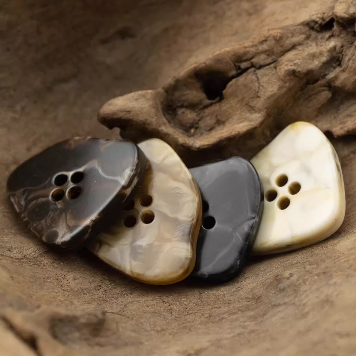 Assorted large irregular resin buttons with marble-look beige, gray, and dark brown finish.