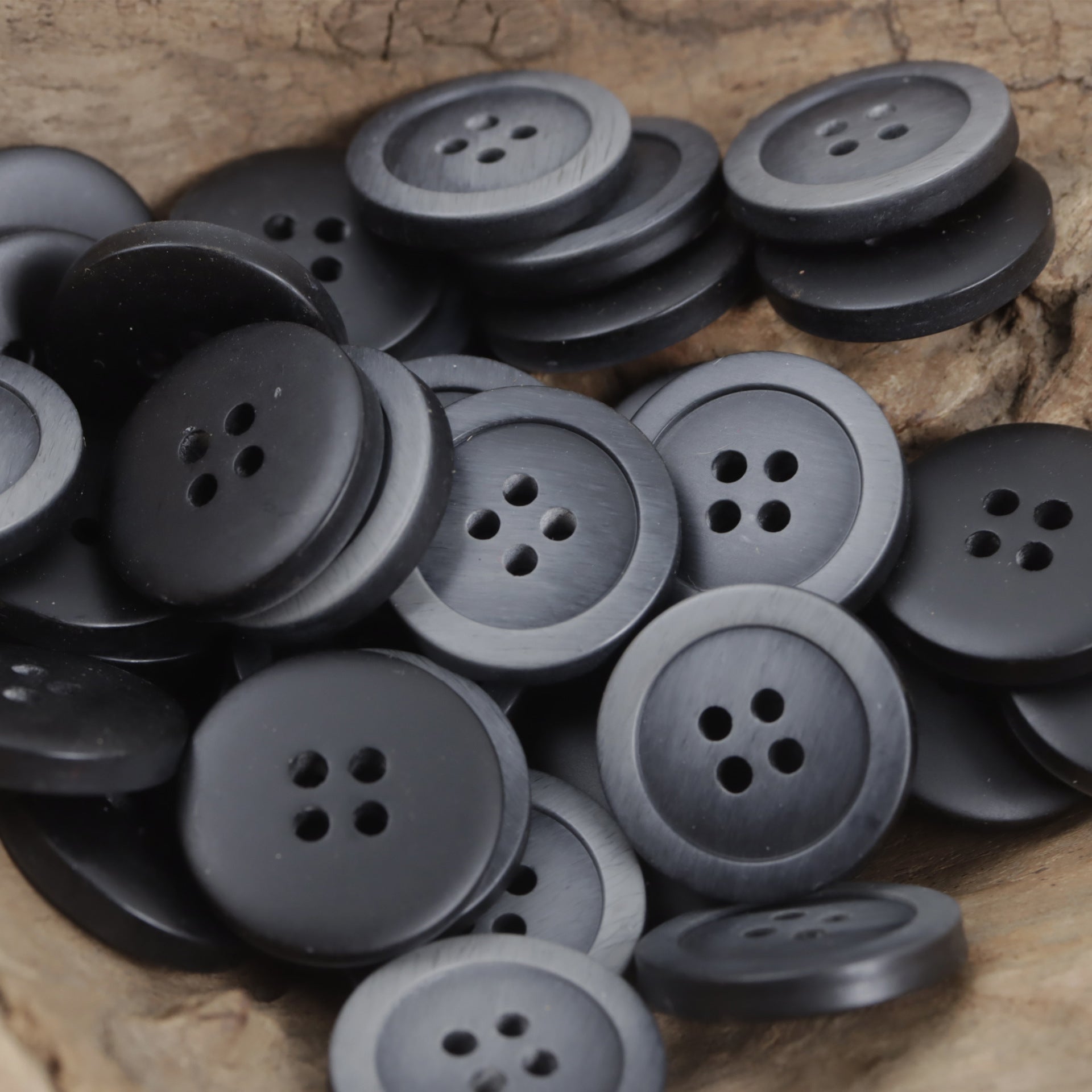 Round dark gray resin buttons with 4 holes, smooth matte finish, 15–25mm
