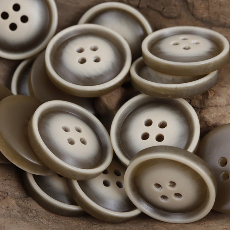 Round resin buttons with 2- and 4-hole designs in light khaki/cream tones