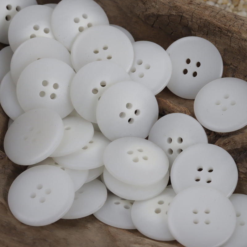 White round resin buttons with 4-hole pattern, bulk pack shown