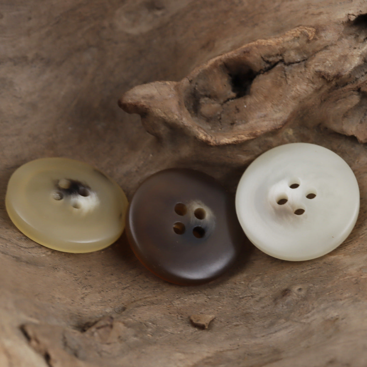 Resin 4-hole buttons in light khaki, coffee brown, and white, three-button arrangement