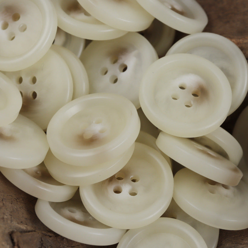 White resin 4-hole buttons, domed face close-up, assorted pieces