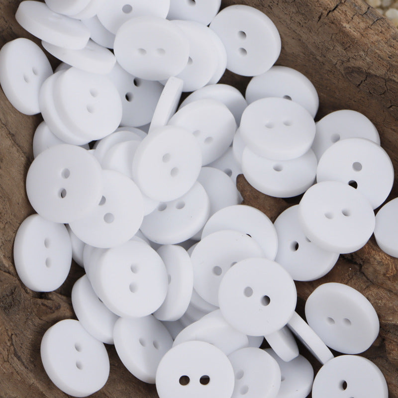 White two-hole round resin buttons with smooth flat fronts