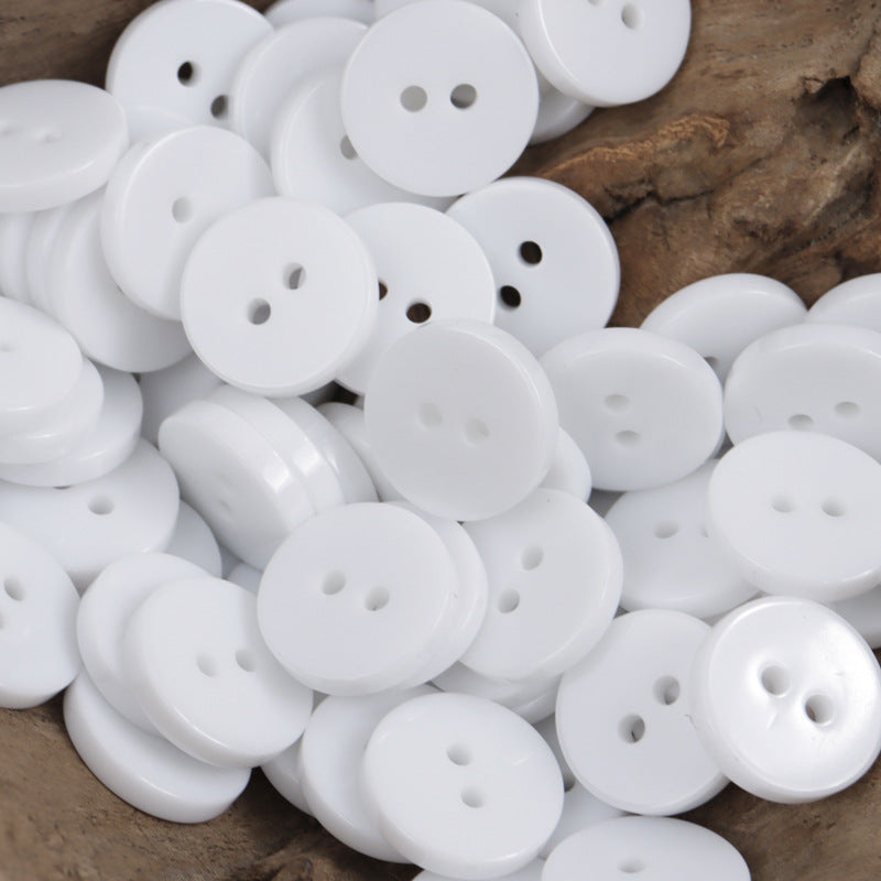 White two-hole round resin buttons, assorted in a pack