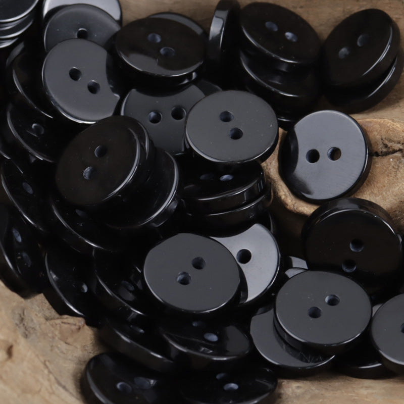 Black two-hole round resin buttons with shiny flat faces
