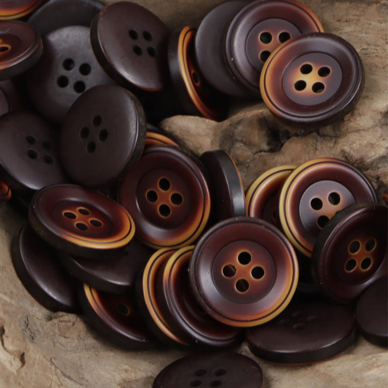 Four-hole resin buttons in deep brown-red with warm orange-brown rims, assorted