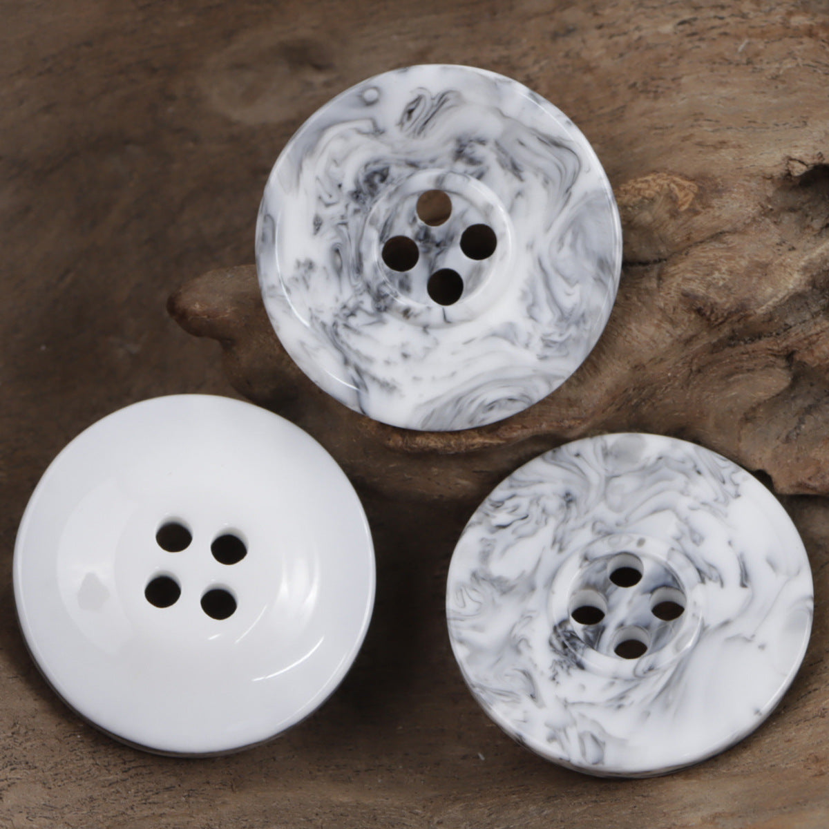 Set of resin buttons in white with gray ink swirls, four-hole styling, assorted views