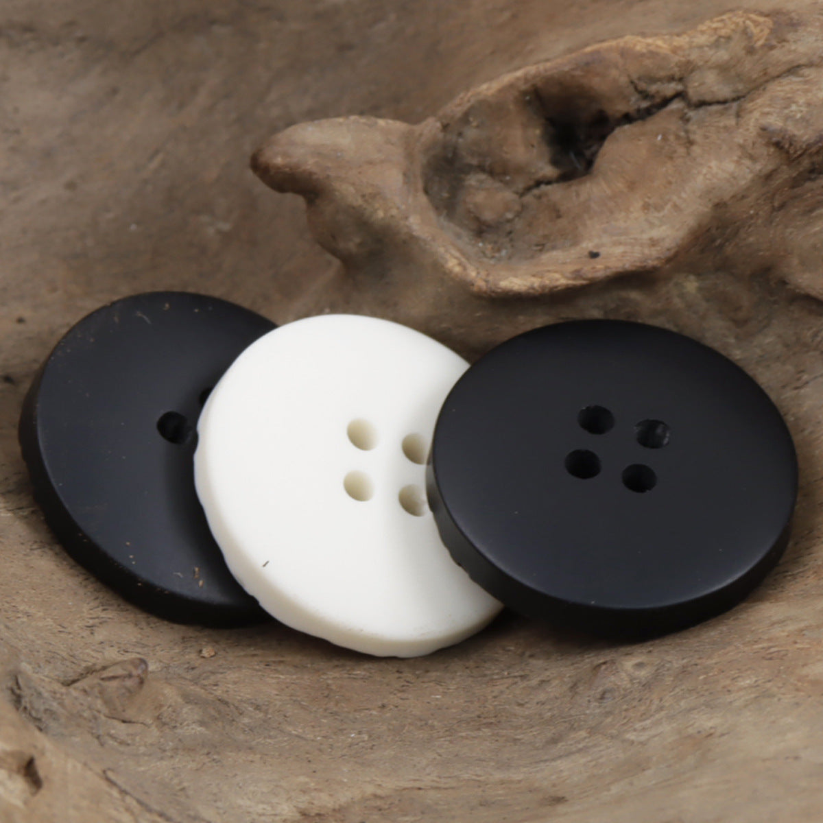 Textured resin buttons for sweatshirts: black and white, round 4-hole fronts (3 pcs).