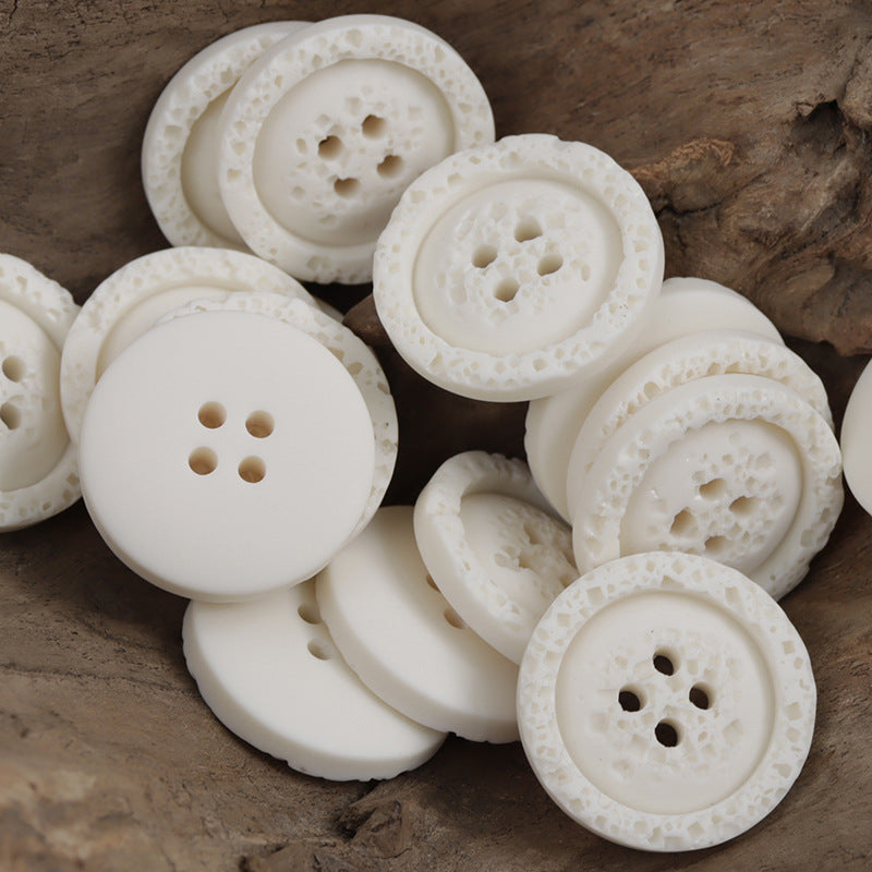 White textured resin shirt buttons, round 4-hole style for sweatshirts (multiple pcs).