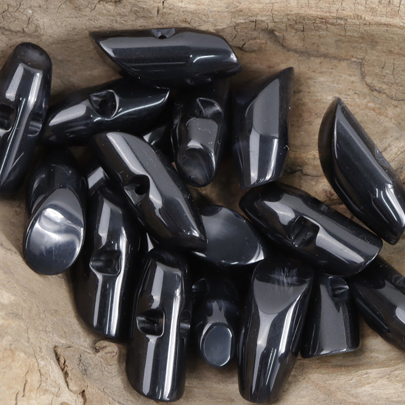 Black irregular horn resin buttons set, glossy teardrop shapes with visible holes