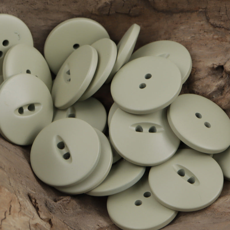 Light green and cream 30mm matte fish-eye resin buttons with two- or three-hole shanks