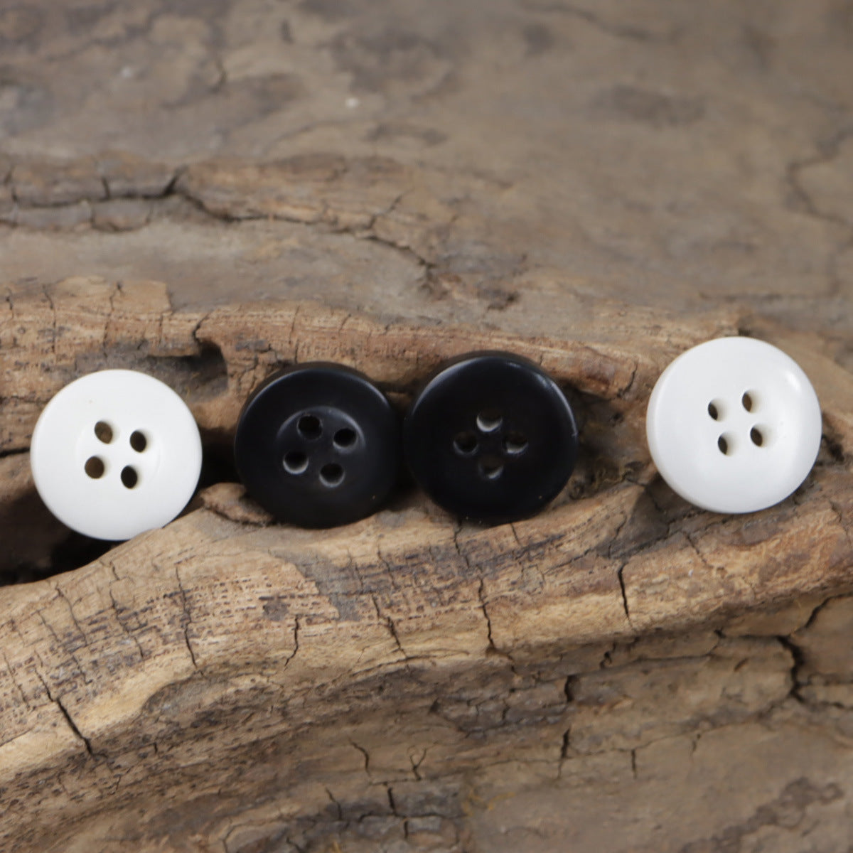 Set of round resin buttons: white and dark, each with four holes