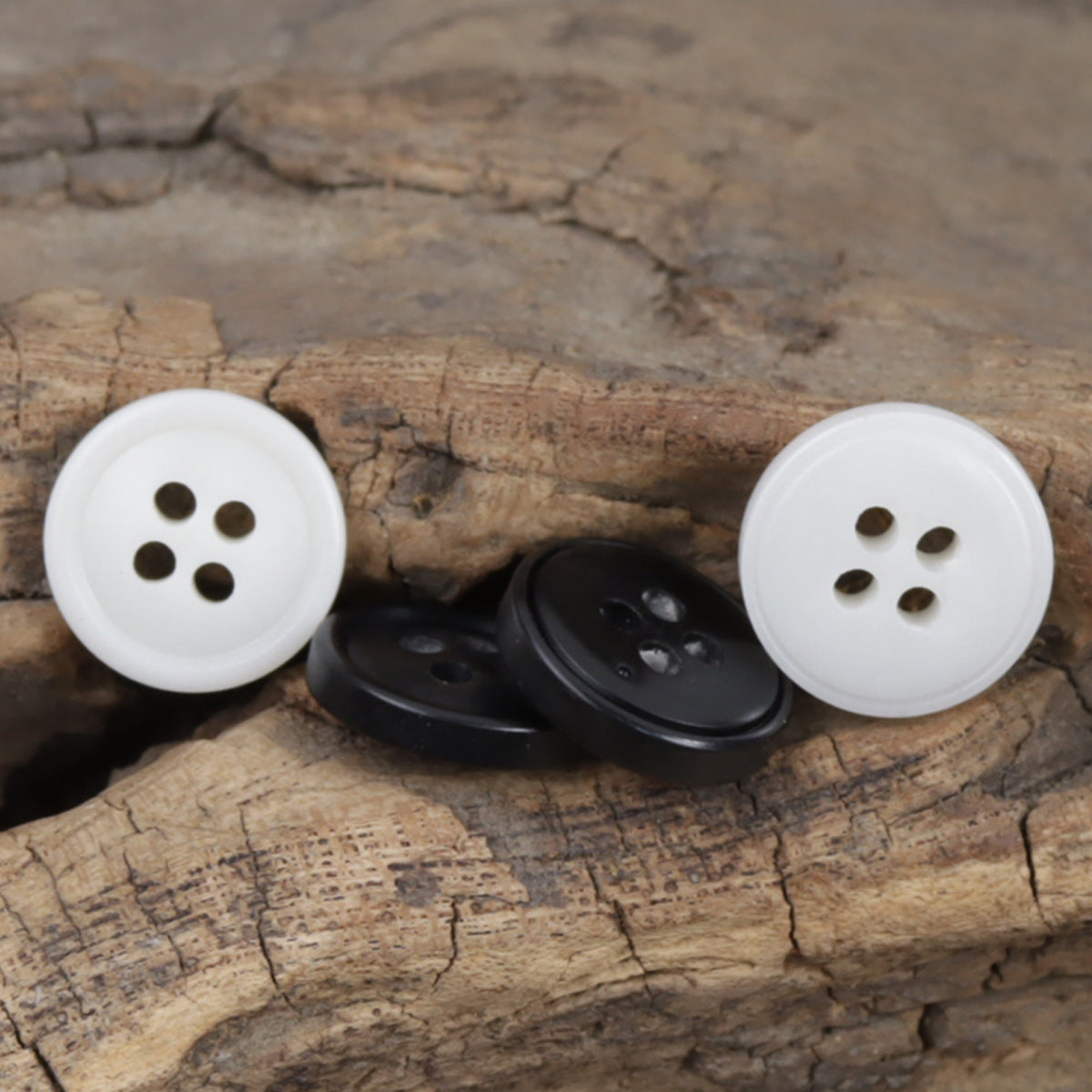 Round resin buttons in white and black, four-hole style for shirt suit