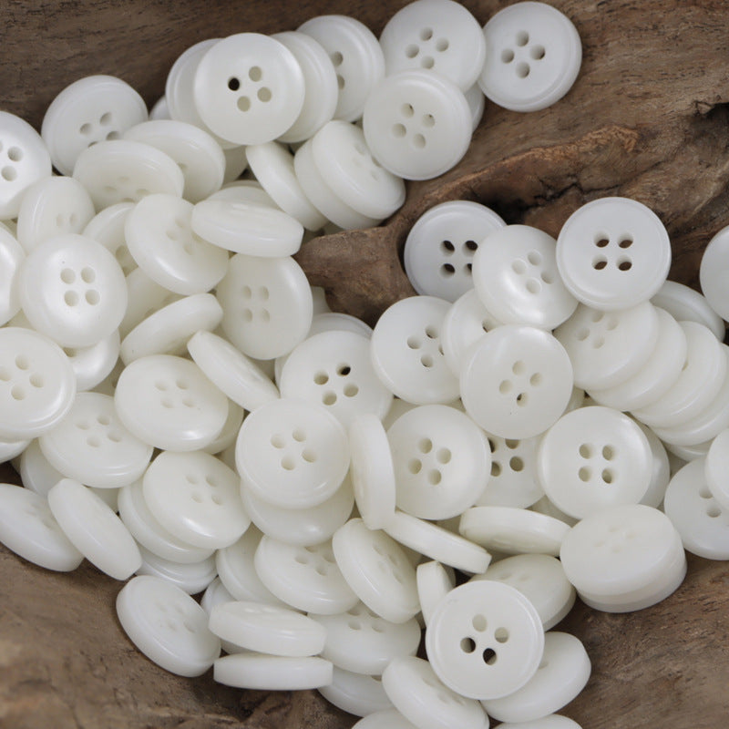 Bag of white round resin buttons with four holes