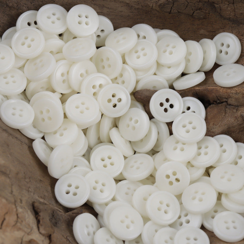 White round resin buttons with four holes, mixed pile view