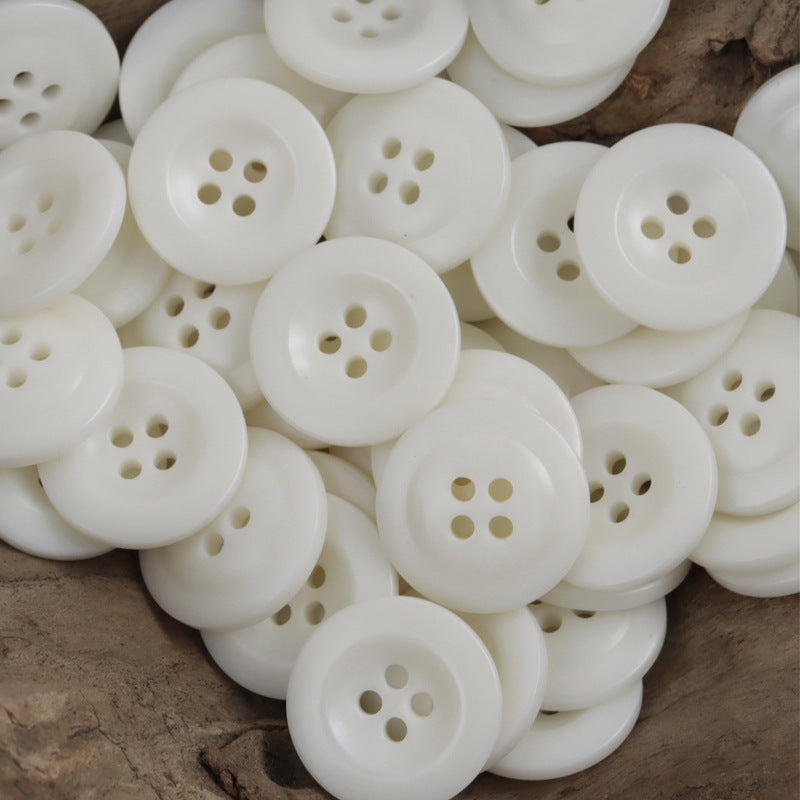 White cap-shaped resin buttons with 4-hole centers, multiple pieces