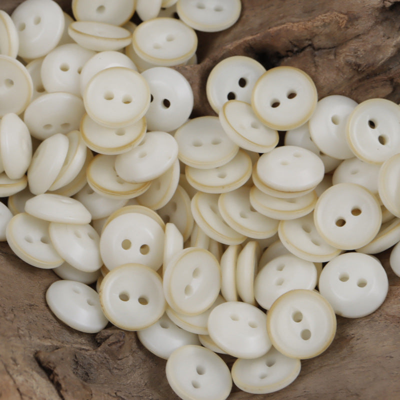 White fish-eye resin buttons, four-hole, glossy, round faces