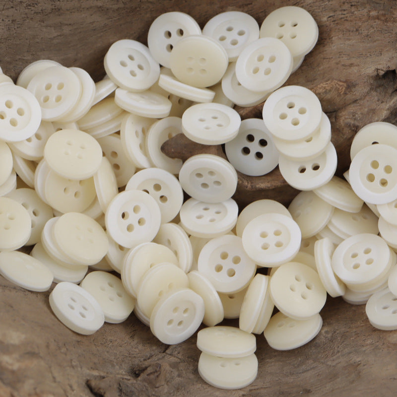 White resin buttons with 4-hole design, 11.5mm, arc-pattern style