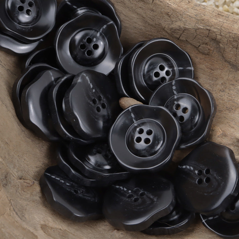 Black irregular lotus resin buttons, four-hole, glossy finish, grouped
