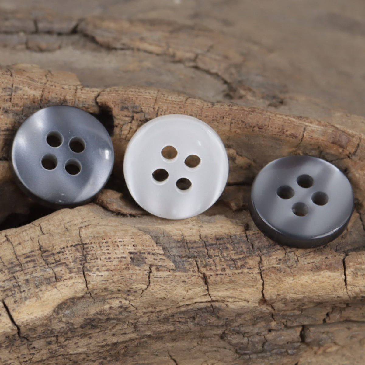 Round 11.5mm resin buttons in gray, white, and dark, each with 4 holes
