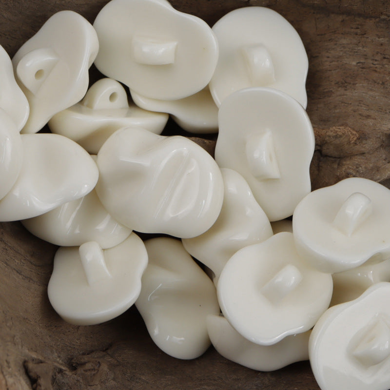 Ivory/white translucent resin jade-texture buttons, irregular rounded shapes, visible holes