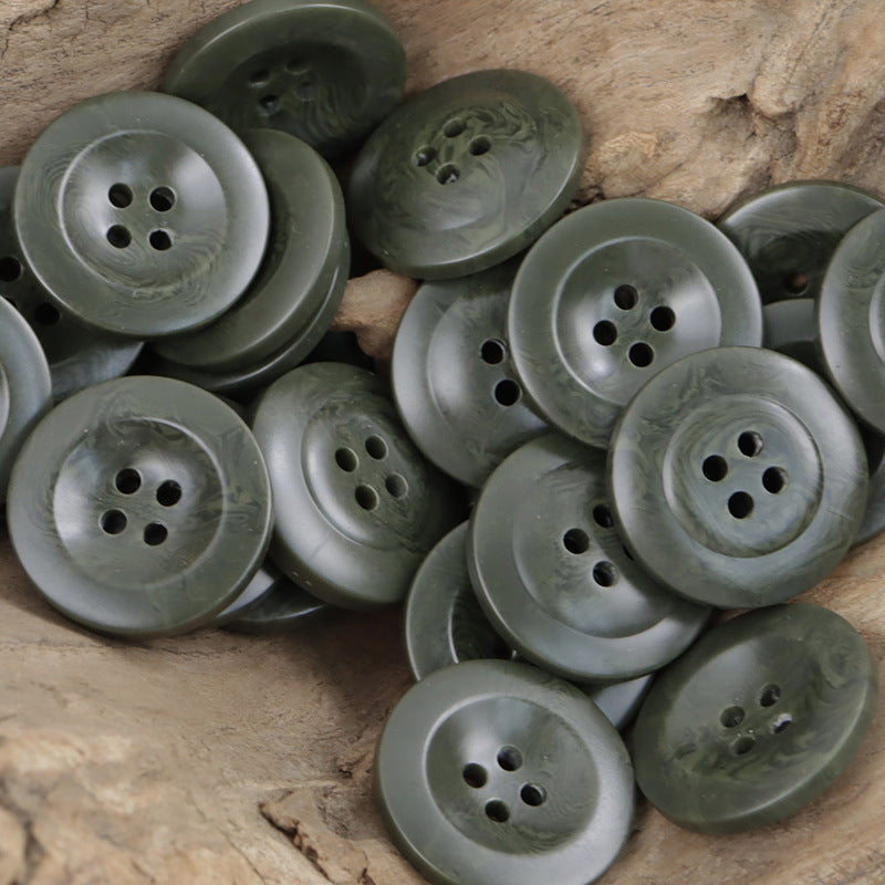 Assorted dark green wide-edge resin buttons, multiple four-hole fronts