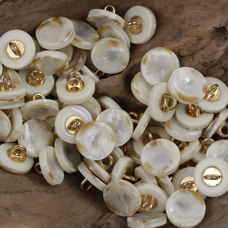 Beige/cream round resin buttons with gold metal shanks, glossy marbled faces