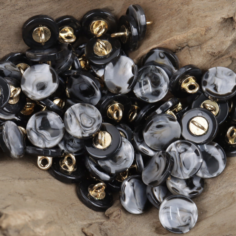 Black round resin buttons with gold metal shanks, glossy marbled front details