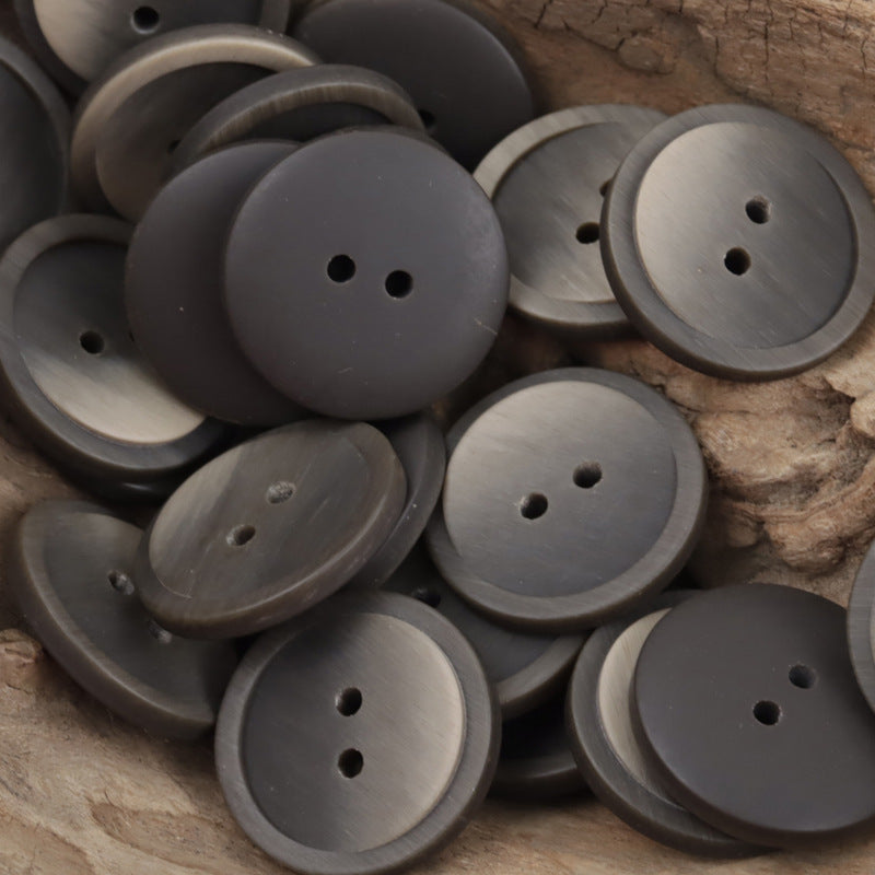 Matte round two-hole resin coat buttons in charcoal and dark gray