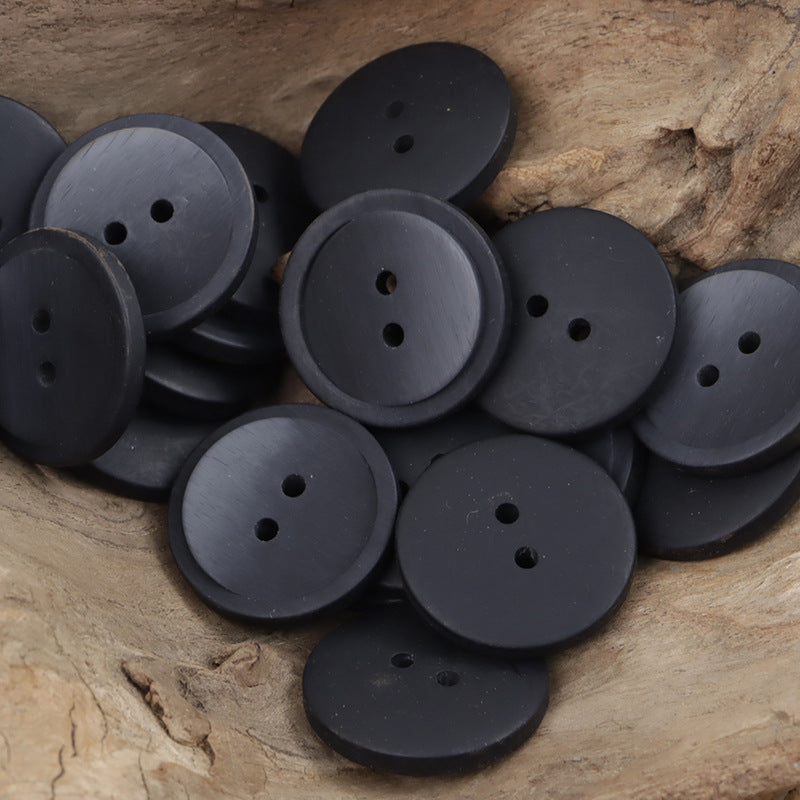 Dark navy/black round two-hole resin coat buttons with subtle sheen