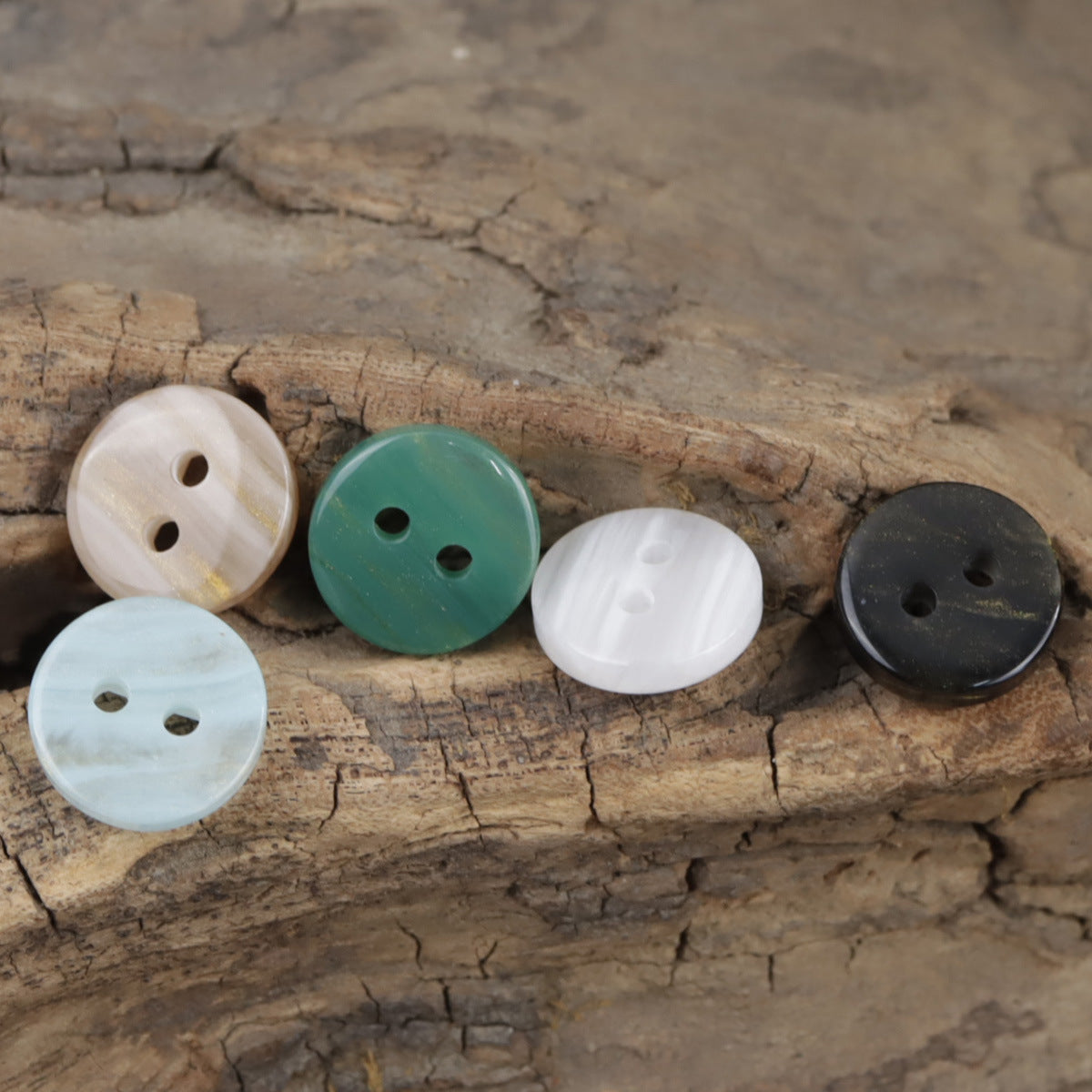 Two-hole resin buttons: white, teal, and dark gray/black with rounded glossy finish