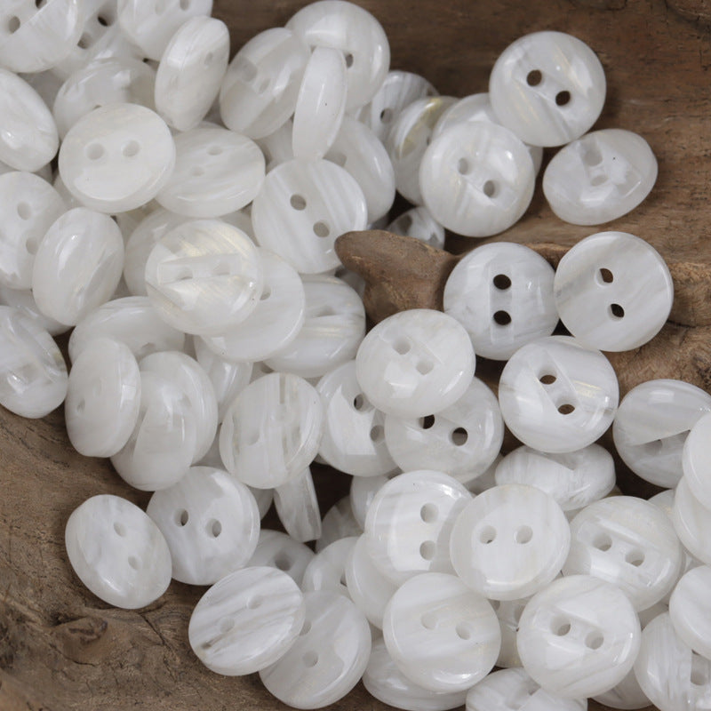 Two-hole white resin buttons, glossy round discs with two holes