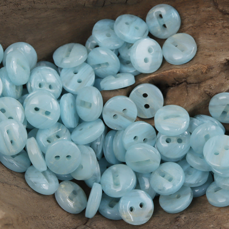 Two-hole light blue resin buttons, glossy round discs with two holes