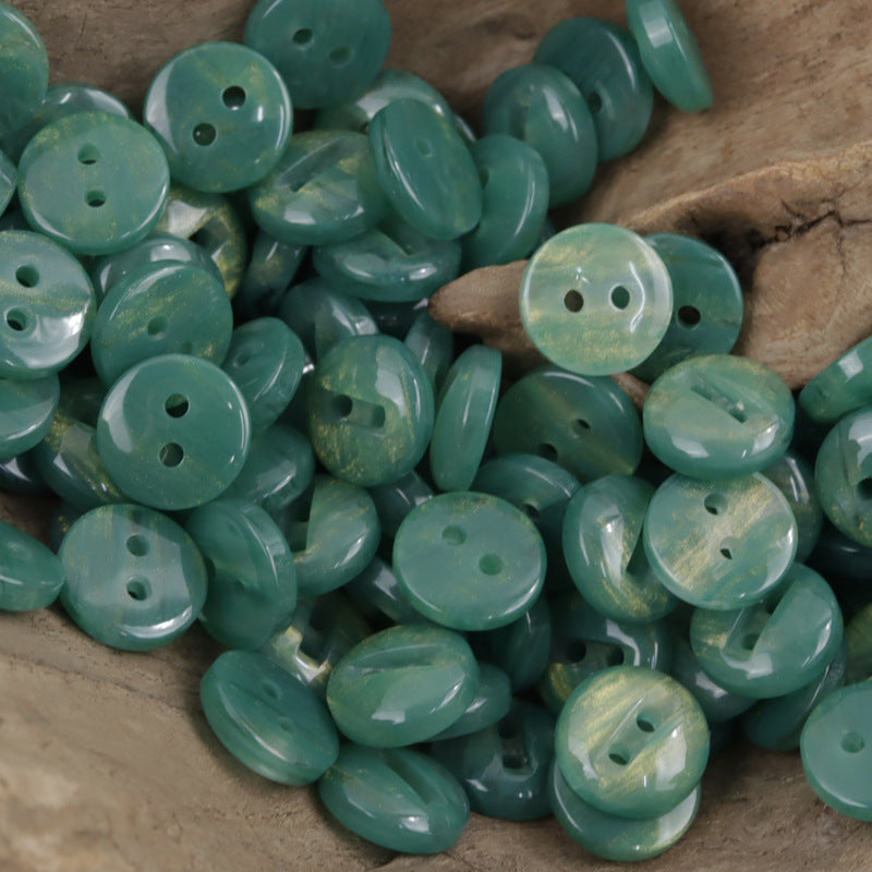 Two-hole green resin buttons, glossy round discs with two holes