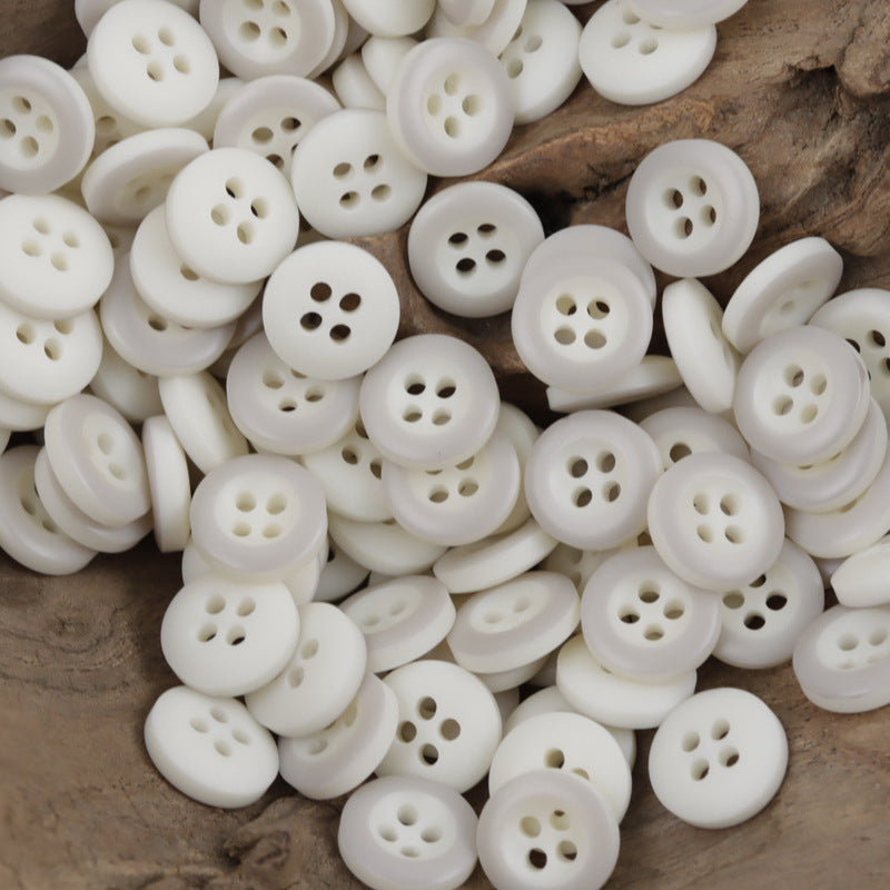 White round resin buttons with 4 holes, multiple buttons close-up