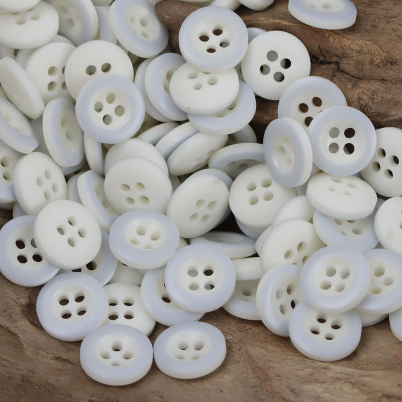 White round resin buttons with 4 holes, front view of button faces