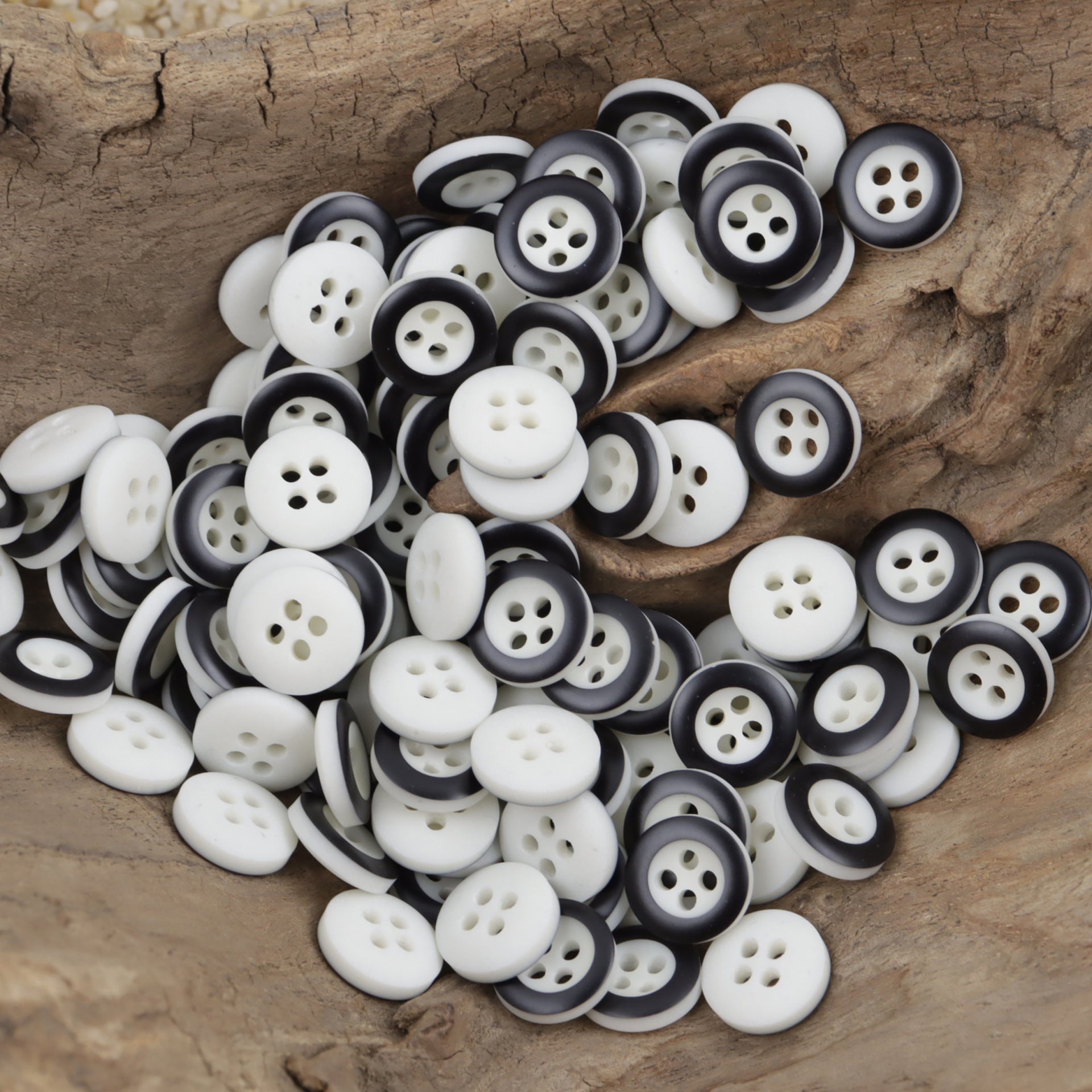 Dark gray/black-and-white round resin buttons with 4 holes, two-tone edges