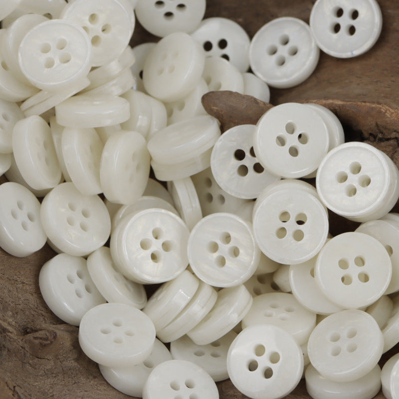 White 4-hole resin buttons mixed with shank-style half buttons (many shown)