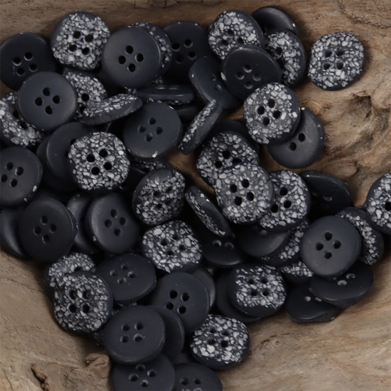 Black moon-surface resin buttons, speckled texture, round discs with four holes