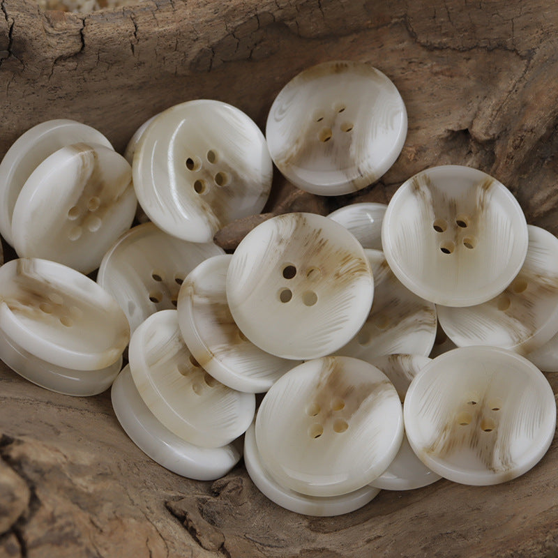 Round 4-hole resin buttons, light khaki, assorted front views in a pile