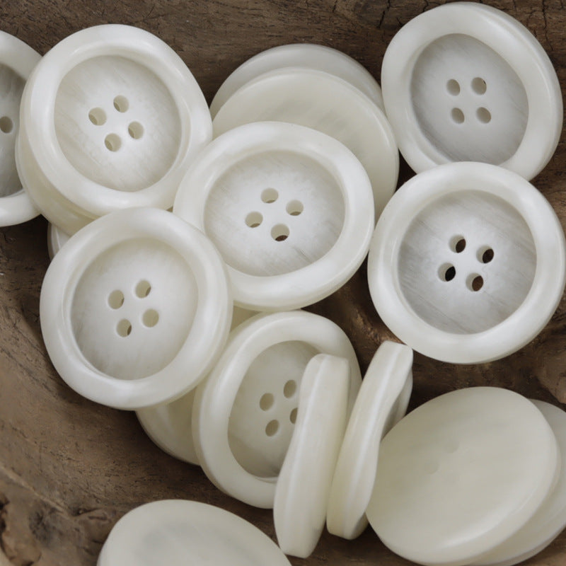 Round resin buttons, off-white with 4-hole face, matte wood-grain texture