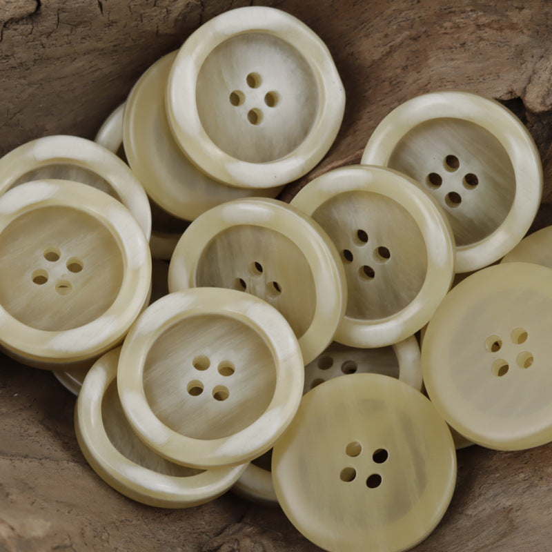 Cream to light-brown resin buttons, round with 4-hole center, wood-grain finish