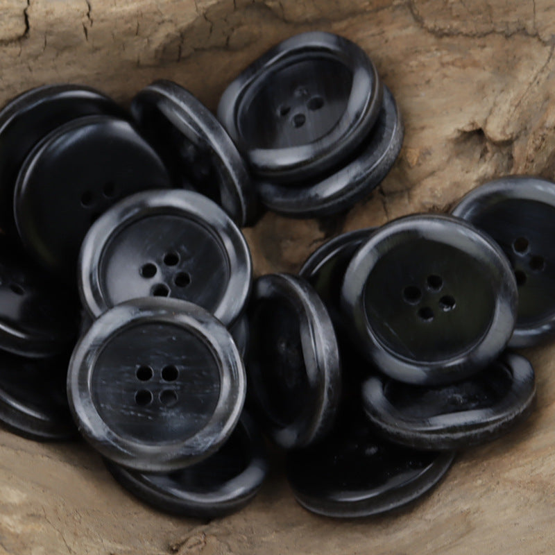Black resin buttons, round 4-hole face with subtle wood-grain pattern