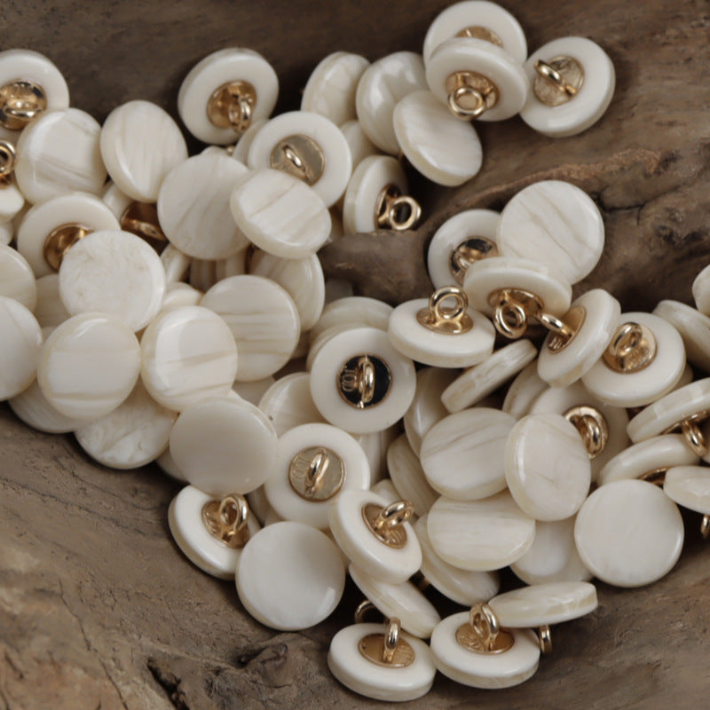 Off-white resin buttons with wood-grain pattern and gold-tone metal shanks, 11.5mm