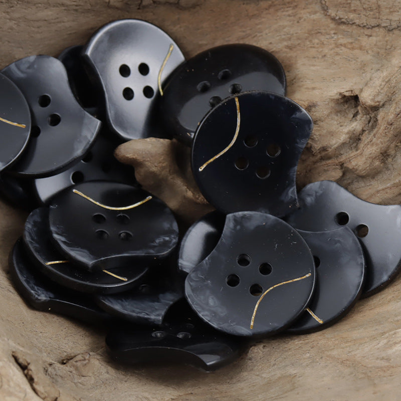 Resin button assortment, black and light gray, four holes, wavy notched edge, gold line