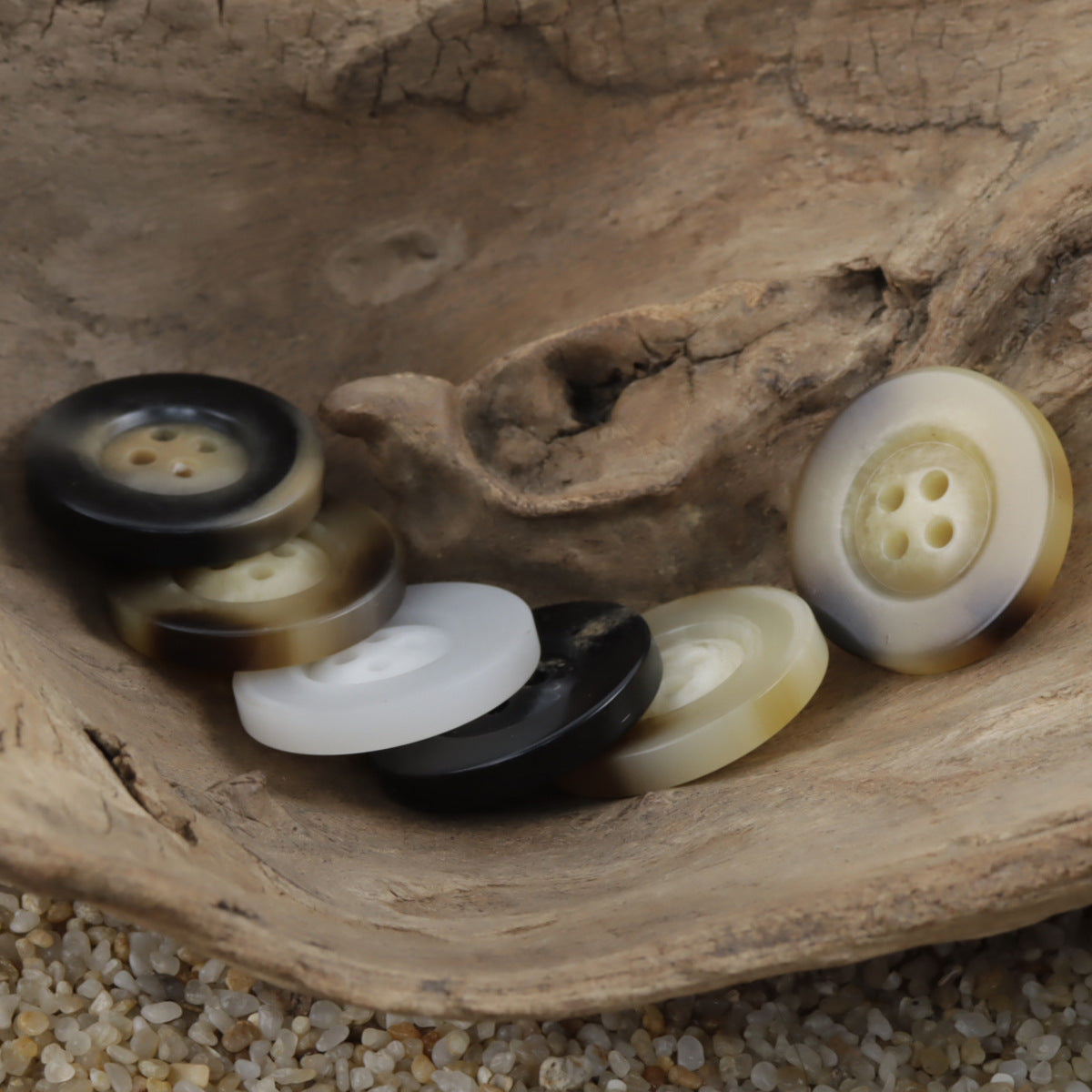 Mixed horn-pattern resin buttons in beige, cream and dark tones, round with 4 holes